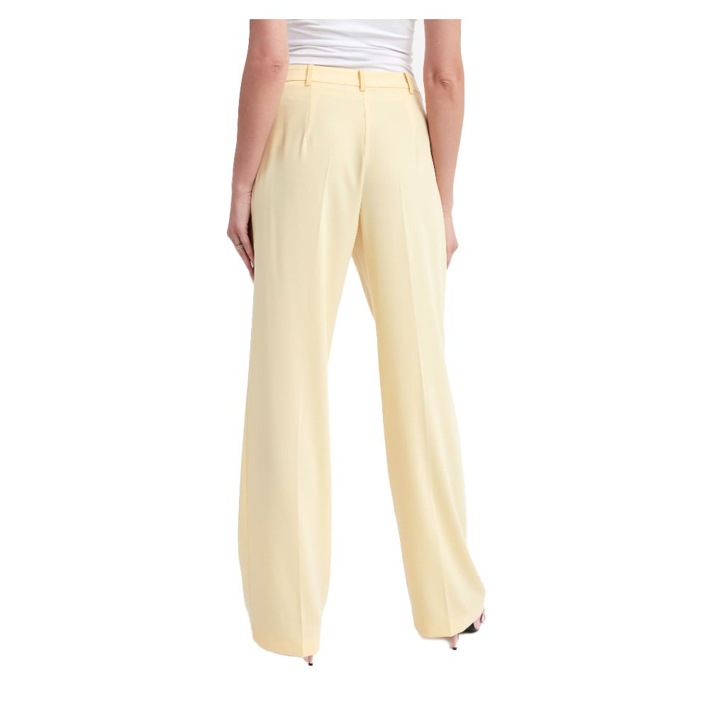 Pantalones elegantes de tejido liso en color amarillo