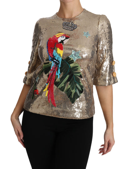 Blusa de cuello redondo con motivo de loro dorado y cristales