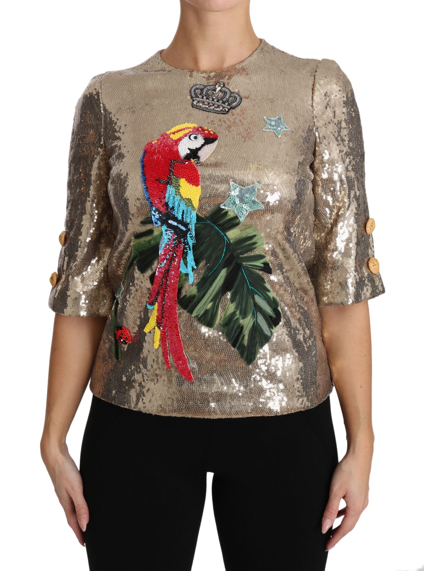 Blusa de cuello redondo con motivo de loro dorado y cristales